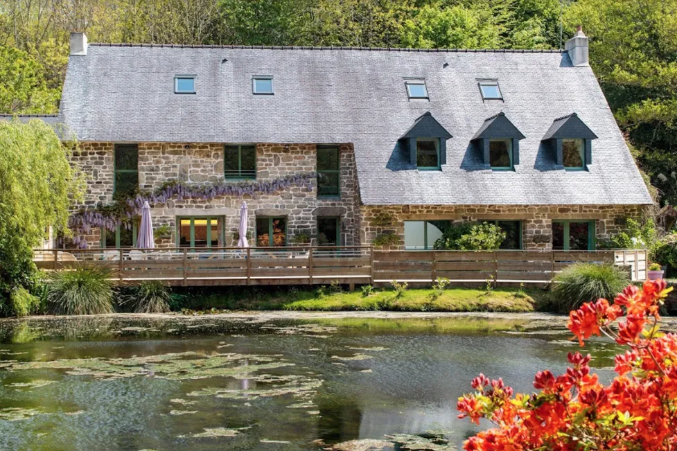 The stone mill and its flower beds beside the pond